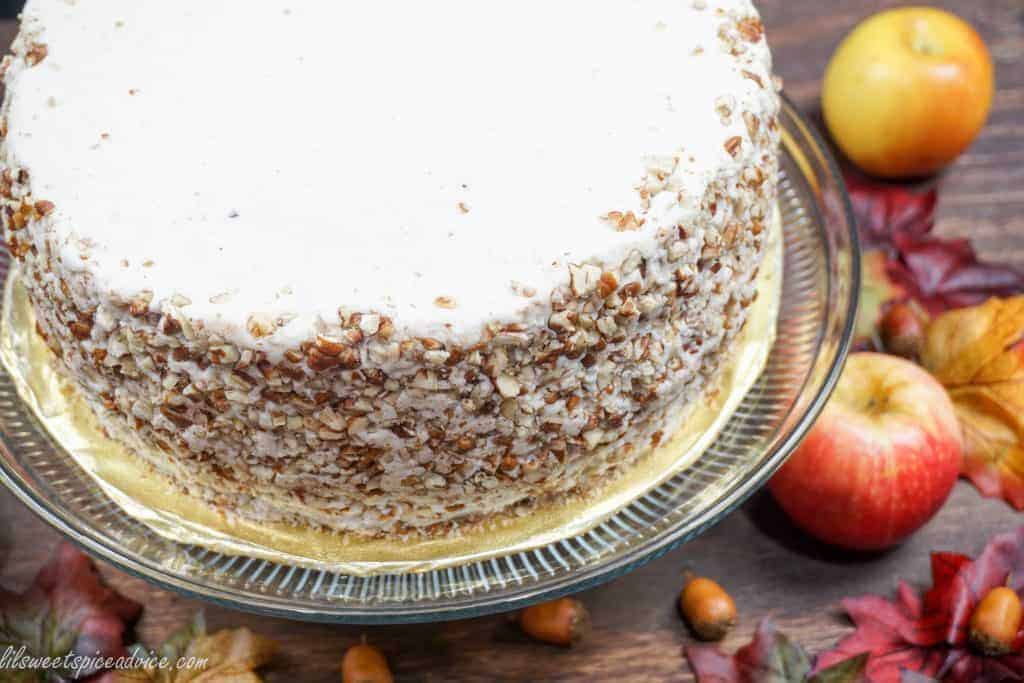 Crown Royal Apple Pecan Cake is the new Carrot Cake! Grated Honeycrisp apples, Crown Royal Apple, and chopped pecans are melded into a spiced cake batter and then frosted with chai spiced buttercream.