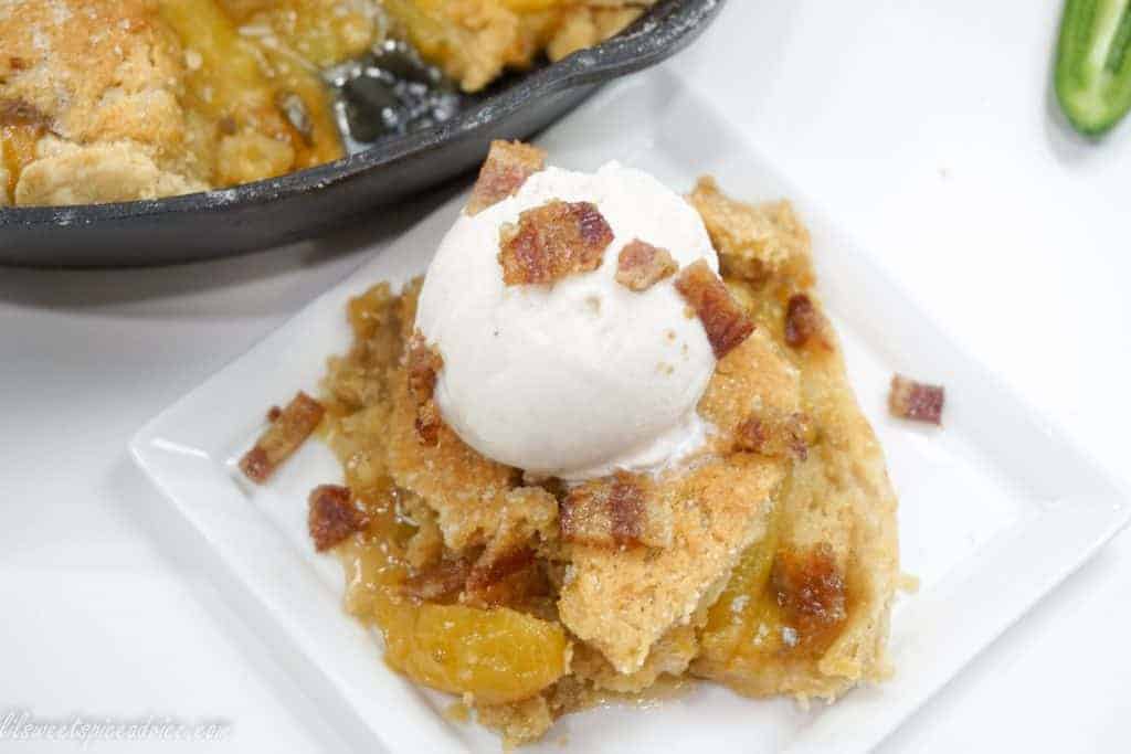 Jalapeño Candied Bacon Peach Cobbler--This is not your grandmother's peach cobbler. This double crust peach cobbler gets a lil' kick from diced jalapeño and a little smokey, crunchiness in the topping from the candied bacon.--lilsweetspiceadvice.com