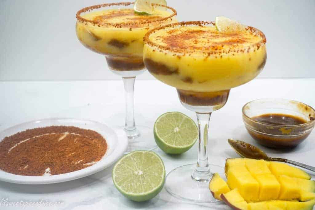 Mangonada Margaritas--Mangonada and margaritas have finally joined together in holy matrimony! Homemade organic chamoy sauce, frozen mangoes, and chili lime seasoning are combined to make a twist on the classic frozen margarita.--lilsweetspiceadvice.com