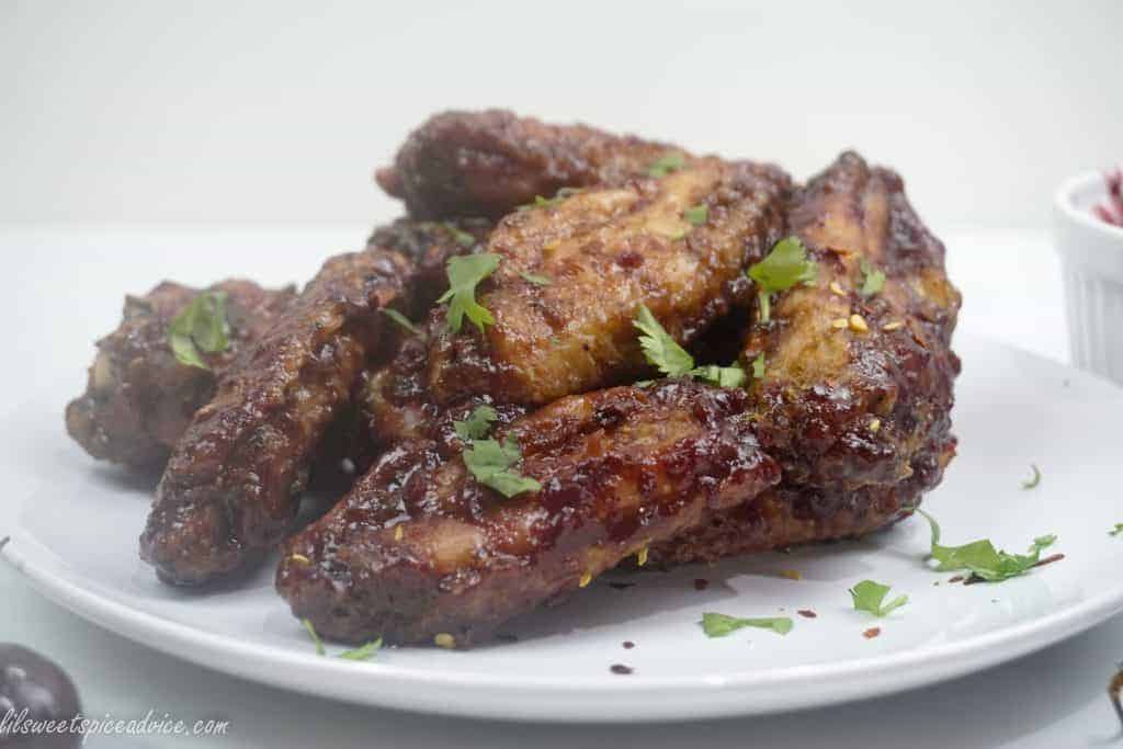Spicy Cherry Glazed Chicken Wings--These Spicy Cherry Glazed Chicken Wings will make you forget all about BBQ sauce wings. Oven baked crispy chicken wings are tossed in homemade spiced cherry glaze and red pepper flakes.--lilsweetspiceadvice.com
