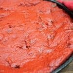 Red Velvet Ooey Gooey Butter Skillet Cookie -- The search for the perfect skillet cookie is officially over! With all of the flavor of a red velvet cake and the gooey butter cake factor this skillet cookie is sure to please the crowd. -- lilsweetspiceadvice.com #skilletcookie #redvelvet #gooeybutter