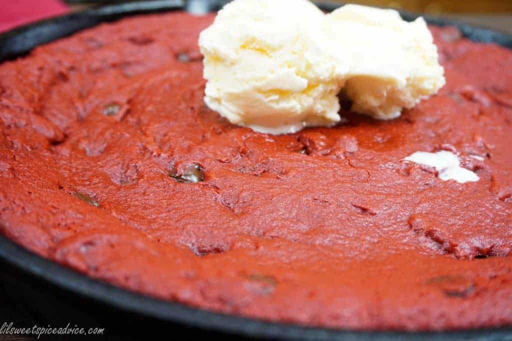 Red Velvet Ooey Gooey Butter Skillet Cookie -- The search for the perfect skillet cookie is officially over! With all of the flavor of a red velvet cake and the gooey butter cake factor this skillet cookie is sure to please the crowd. -- lilsweetspiceadvice.com #skilletcookie #redvelvet #gooeybutter