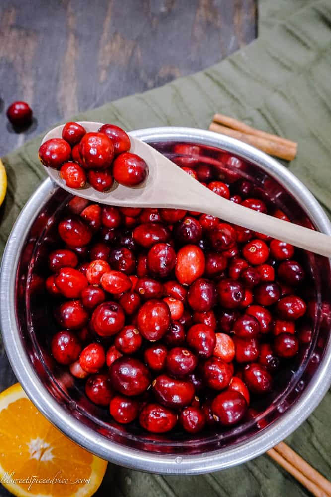 Bourbon Orange Vanilla Cranberry Sauce -- You need the best cranberry sauce to place on your Thanksgiving table this year. This Bourbon Orange Vanilla Cranberry Sauce is a must try and will impress all of your guests! -- lilsweetspiceadvice.com #cranberrysauce #bourboncranberrysauce #orangecranberrysauce #easycranberrysauce