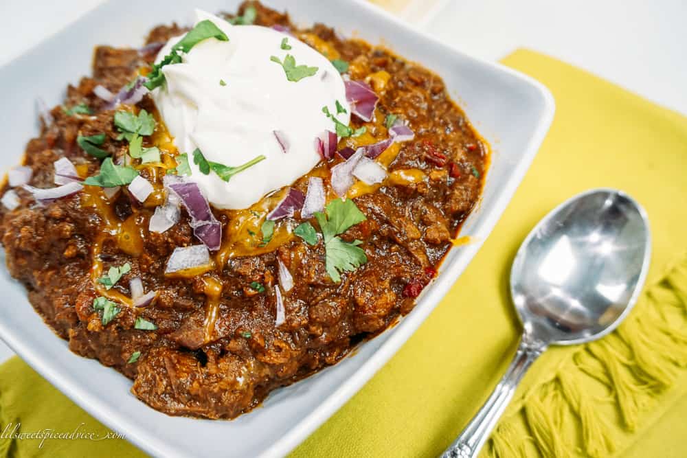 Instant Pot Texas Chili -- This bold and spicy Instant Pot Texas Chili is full of chunky cuts and ground chuck roast, spiced with a homemade chili paste, and is on your table in under two hours and tastes like it's cooked for hours! -- lilsweetspiceadvice.com #InstantPotTexasChili #TexasChili #chilinobeans #lilsweetspiceadvice